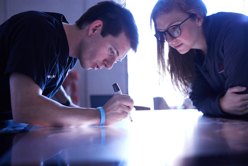 Two students work on virtual table top for class assignment