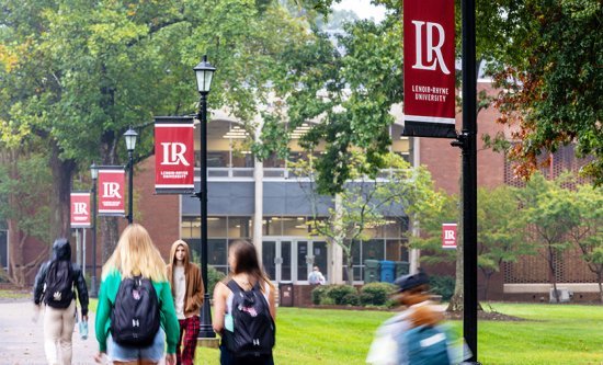 Students walking in front of library between classes