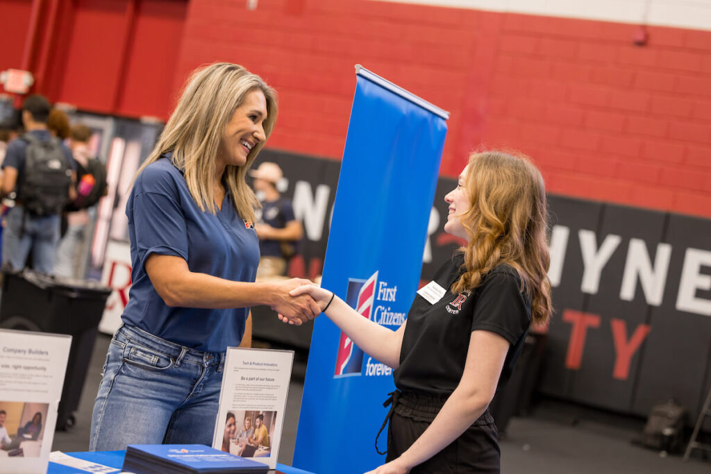 An employer talks with an LR student during career fair on campus