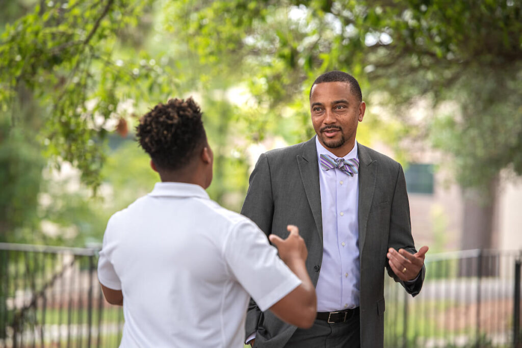 Professor talks with student outside after class