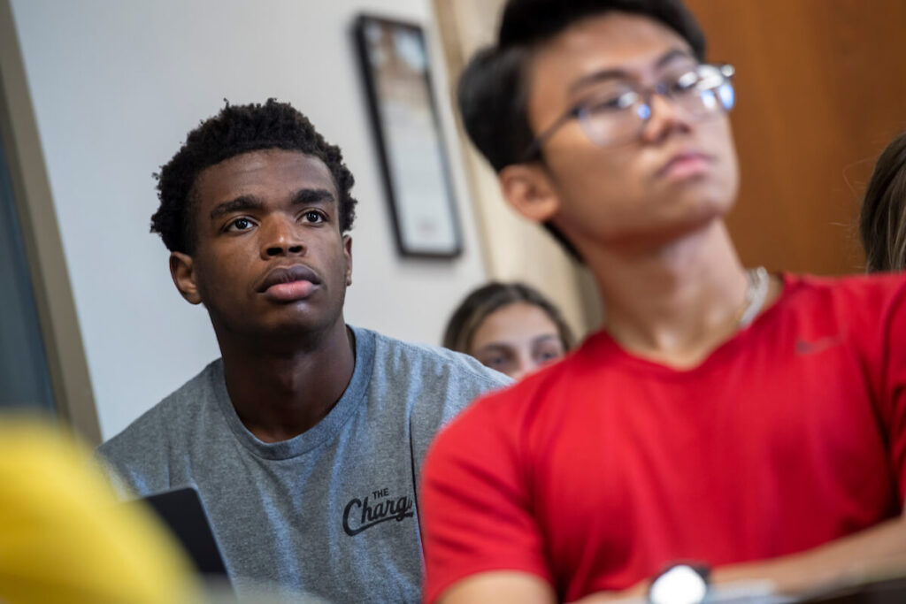 Two students listen intently during class