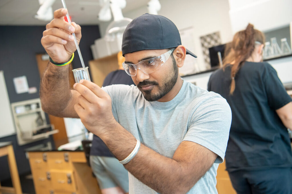 Student works with a pipet and beaker during science lab